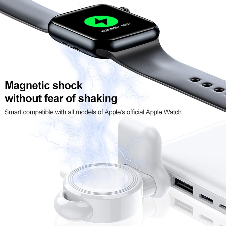 Black magnetic wireless charger on strap with Apple Watch resting on white base dock