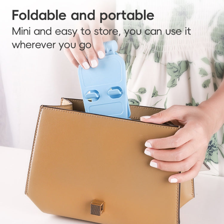 Foldable portable phone stand, light blue, stored in a small case