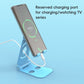 Foldable phone stand, light blue, holding a phone with charging cable connected