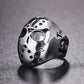 Skull mask ring with circular eye openings and dotted embellishments, silver with black accents