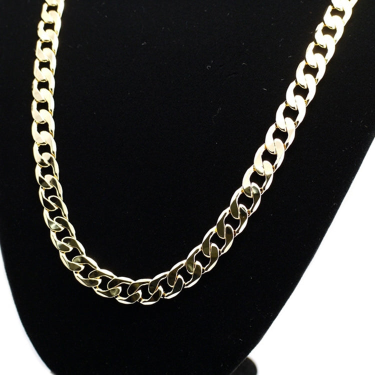 Gold curb-link chain necklace detail with interlocking oval links