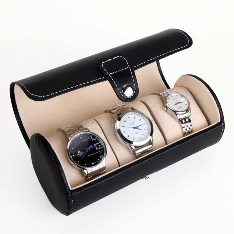 Black cylindrical watch storage bag with beige lining, holding three watches on cushions