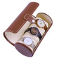 Brown cylindrical watch storage bag with beige lining, holding three watches in slots