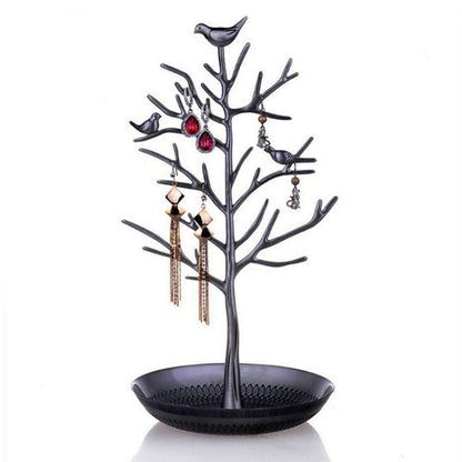 Black tree-shaped jewelry display rack with bird charms and round earring tray