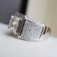 Silver rhinestone ring with a large faceted center stone and pavé rectangular face