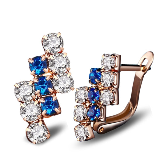 Rose gold-tone crystal cluster stud earrings with blue stones and clear accents