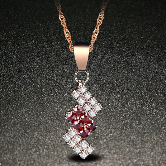 Gold-plated crystal pendant necklace with red center and clear square accents