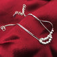 Silver-tone anklets with thin chains, frosted beads, and heart-shaped clasps