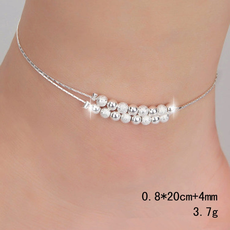Silver-tone anklet worn on ankle with frosted bead row and small star charm