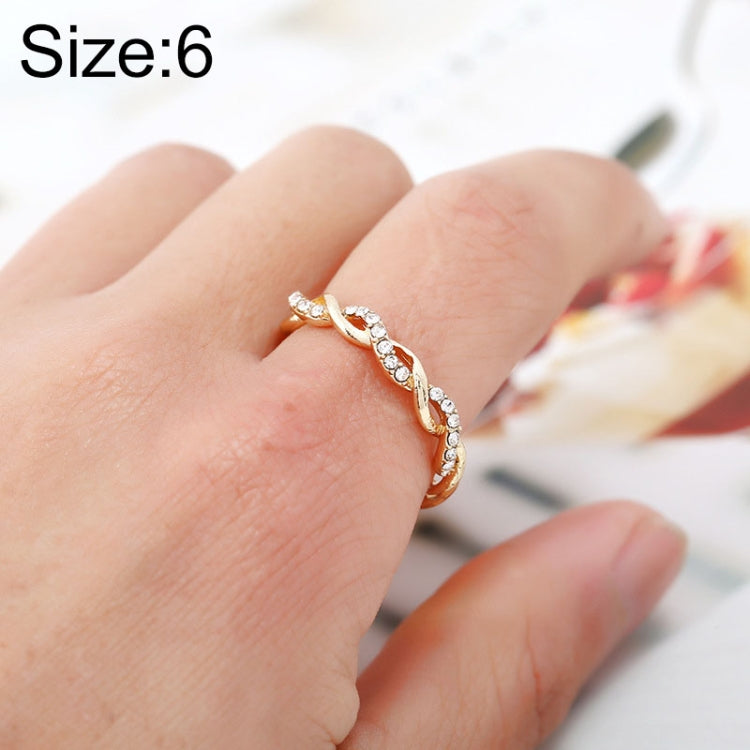 Gold twisted rhinestone ring on finger, all-around sparkle