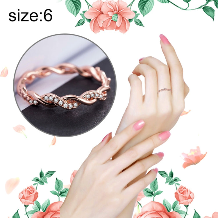 Rose gold twisted rhinestone ring on hand, oval stone settings