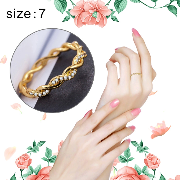 Gold twist rhinestone ring on finger, women’s size 7