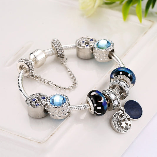 Beaded charm bracelet with blue stones and circular charms, silver-tone chain bracelet
