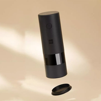 Electric pepper grinder, black cylinder with button and clear base chamber