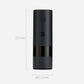 Black electric pepper grinder with round button and compact cylindrical body