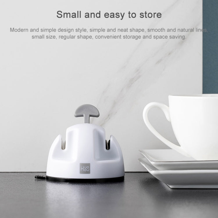 White compact double-wheel knife sharpener on countertop near a mug