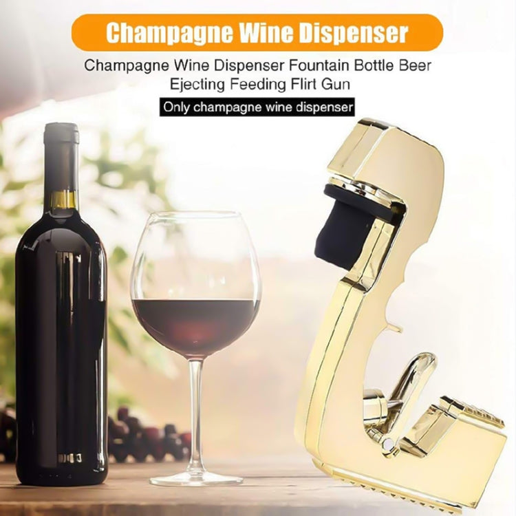 Gold bubble squirt gun beside bottle and wine glass, ready to dispense champagne bubbles