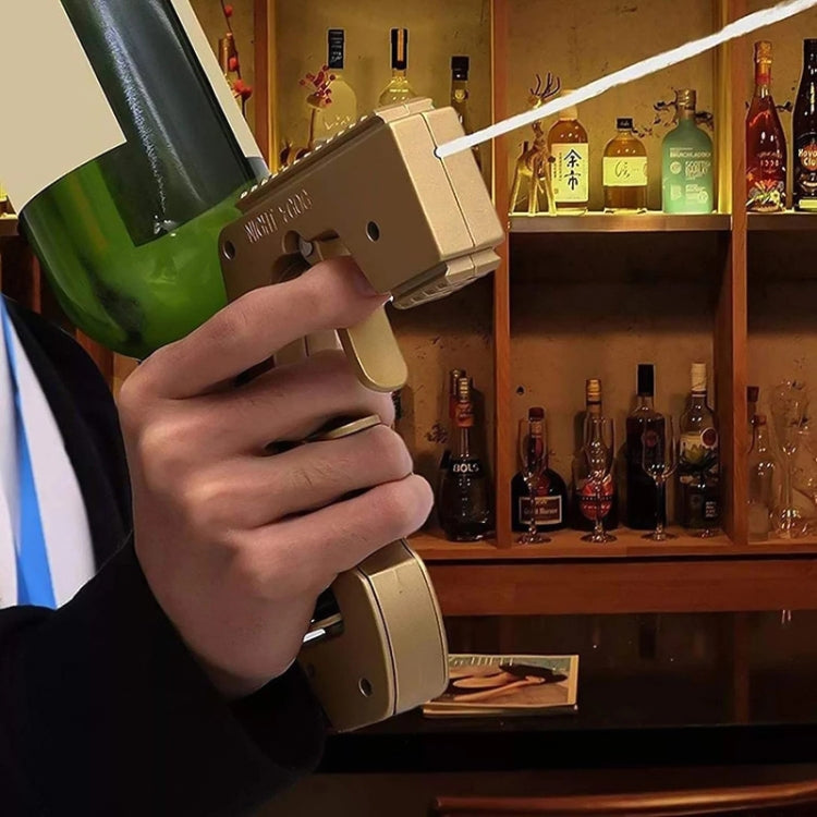 Bottle-shaped squirt gun with plastic wrap and metal body, held in hand