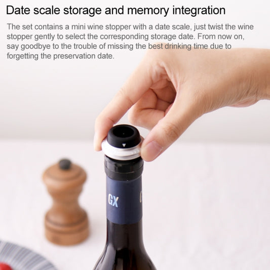 Wine stopper set: hand inserts a black vacuum stopper into a wine bottle