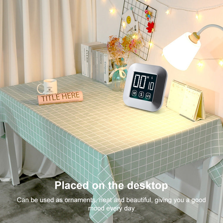 Digital touch timer alarm clock placed on a desktop with large LCD countdown display