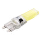 Transparent LED plug bulb side view with yellow COB strip and two pins