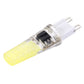 Dimmable LED plug bulb close-up, clear body with white light strip and two pins
