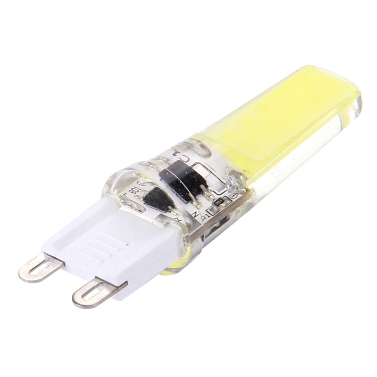 Dimmable LED plug bulb, clear body with warm yellow strip and two prong pins