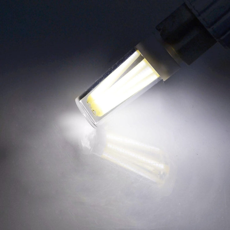 G9 dimmable LED bulb lit, warm white light emitting from clear glass