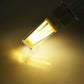 Lit E14 dimmable LED bulb with warm yellow glow, clear glass, silver screw base
