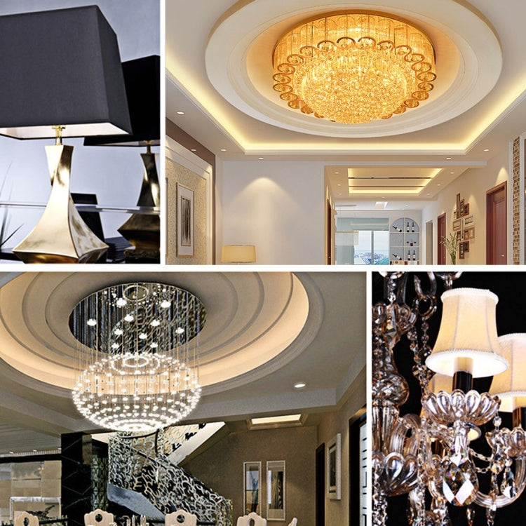 Ceiling chandelier and pendant light fixtures with warm amber glow in a room