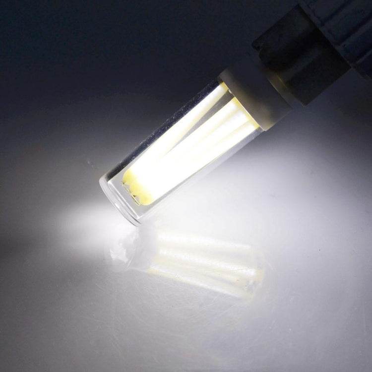 Warm white G9 dimmable LED lamp glowing inside a dark fixture area