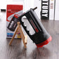 Black LED flashlight with red base and side vents, angled view