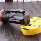 Black and red flashlight beside yellow charging base dock, rear view