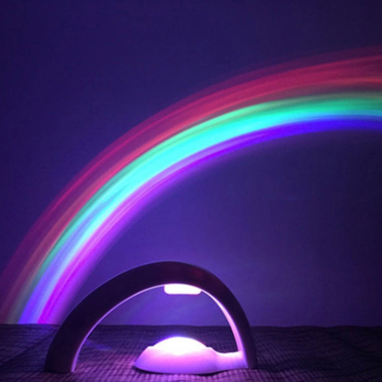 LED rainbow projection night light with curved base, glowing multicolor arc
