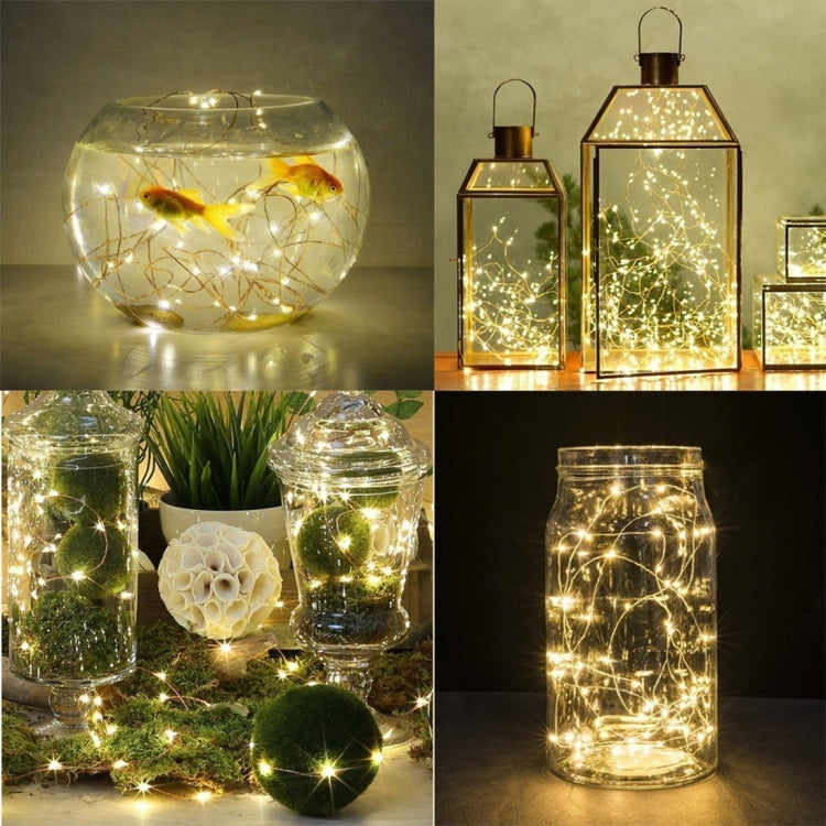 Warm white fairy lights in glass lanterns and jar containers, softly glowing
