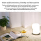 White bedside night light lamp with smooth rounded body on a carpet