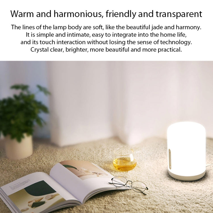 White bedside night light lamp with smooth rounded body on a carpet