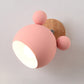 Pink globe-shade wall lamp with wooden backplate and side ball detail