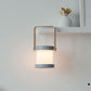 White and wood lantern lamp on shelf, glowing ribbed light base within frame