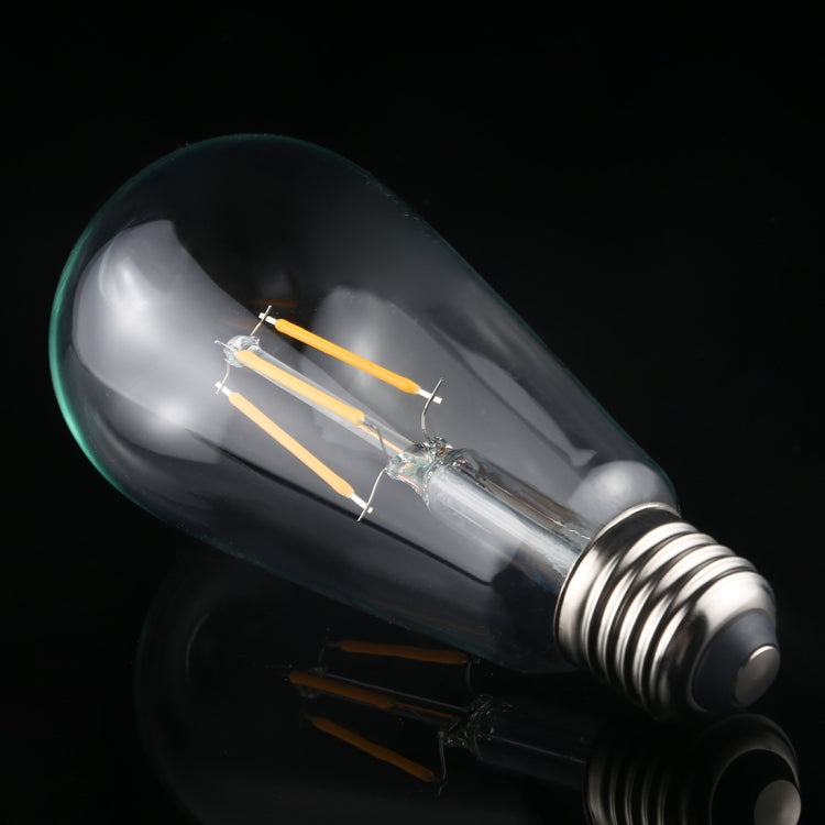 Smoke-gray ST64 LED filament bulb with warm filament bars and E27 screw base.