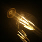 Warm-glowing ST64 LED filament bulb in clear glass with E27 screw base.
