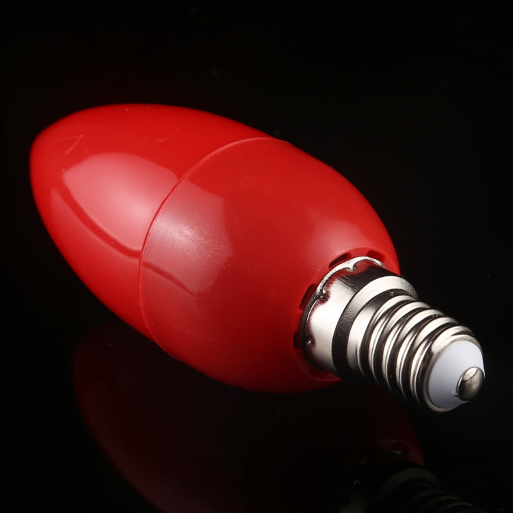 Red LED bulb close-up with metal E14 base threads and rim at bulb opening