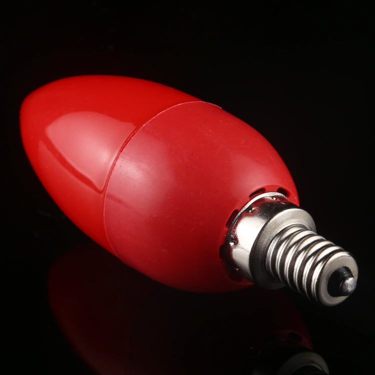 Red LED light bulb close-up with metal screw base and glossy finish