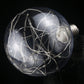 Clear glass retro LED filament bulb with E27 base, tangled wire loops inside, unlit