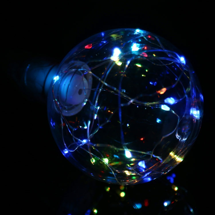 Retro LED filament bulb glowing with blue and multicolor lights inside clear glass globe