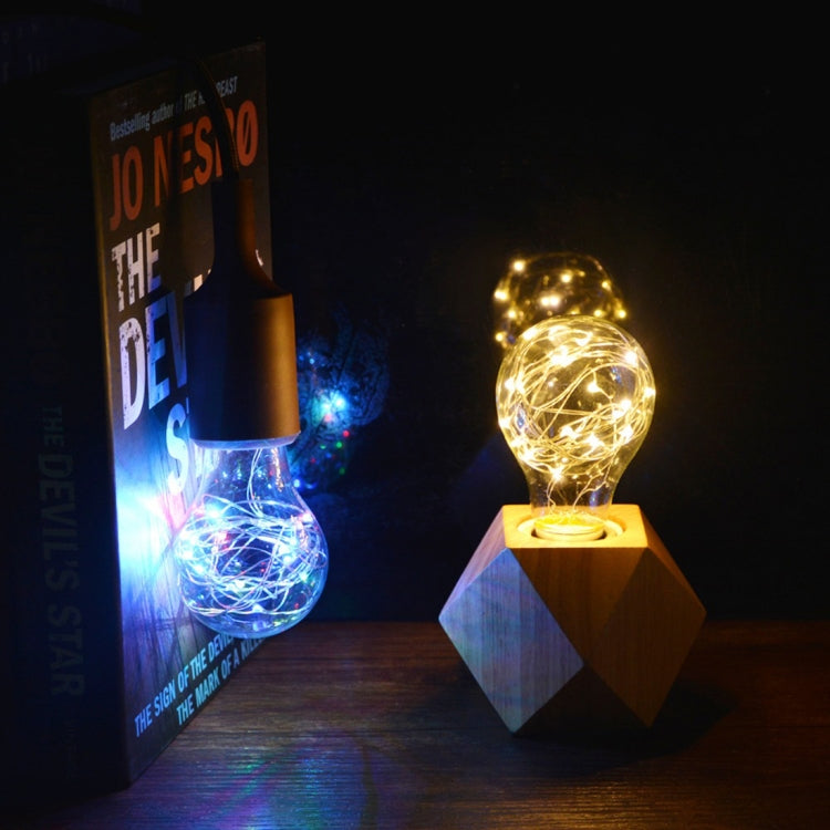 Globe LED filament bulb glowing with warm light and twinkling wire strands in clear glass