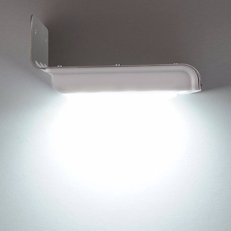 White solar wall light showing illuminated LED bar under the hood
