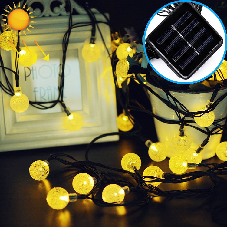 Solar LED bubble ball string lights with warm white globe bulbs on black wire