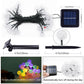 Solar LED bubble ball string lights set with clear globe bulbs, solar panel, and ground stake