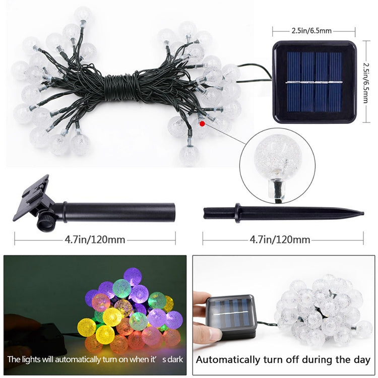 Solar LED bubble ball string lights set with clear globe bulbs, solar panel, and ground stake